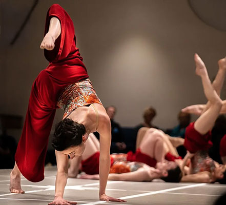 promotional photography for interzone performance featuring dancers wearing red